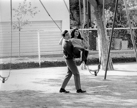 Paul Peterson with Brenda Benet on a swing c. 1965