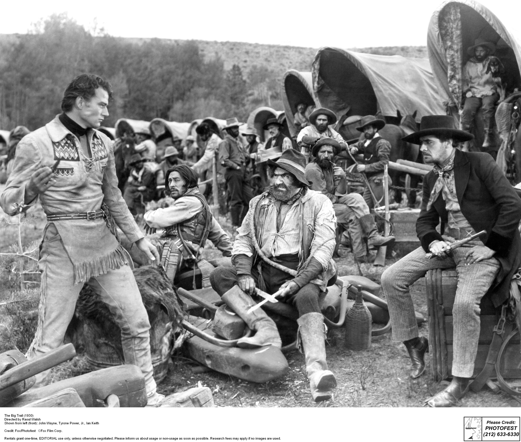 Still of John Wayne, Ian Keith, Tyrone Power Sr. and Charles Stevens in The Big Trail (1930)