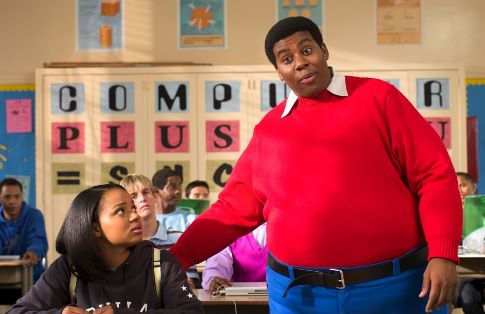 As Doris (Kyla Pratt) looks on in embarrassment, Fat Albert (Kenan Thompson) explains to her class why she needs his help.