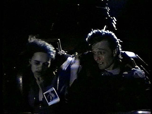 Max (John Pyper-Ferguson) with Lori (Chantelle Jenkins) grabs for the photo in a runaway coaster in David Winning's KILLER IMAGE (1992)