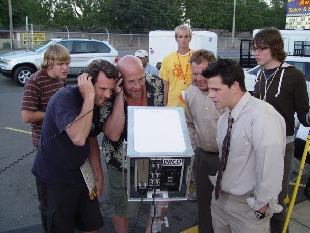 Director Craig Richards studies video playback after a take on location for the feature-length comedy 