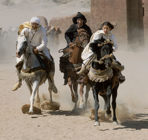 Neera (Biana Tamimi, right) rides hard on Shetan against Mansoor (Ali Al Ameri, center) and Rhamon (Gerard Rudolf, left), both of whom have designs on her horse.