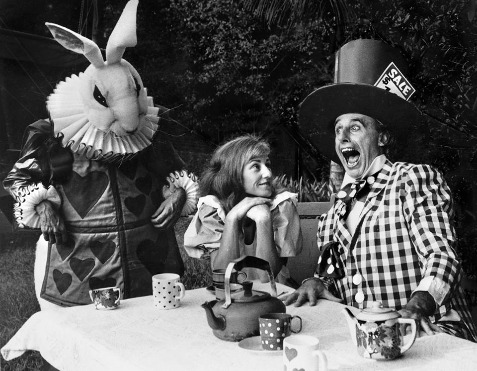 Ricardo Rusch as the White Rabbit with Janet Bowran as Alice and Trevor Hughes as the Mad Hatter in play Alice in Wonderland directed by Buck Richardson
