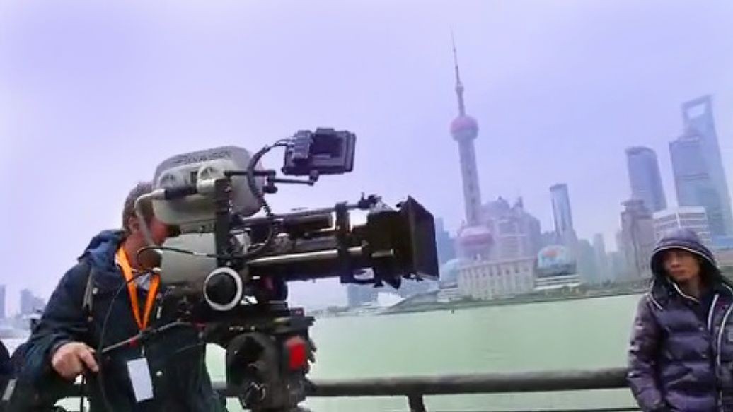 Director Rian Johnson sets up a shot on the famous Bund (boardwalk) in Shanghai, China for his Sci-Fi hit 