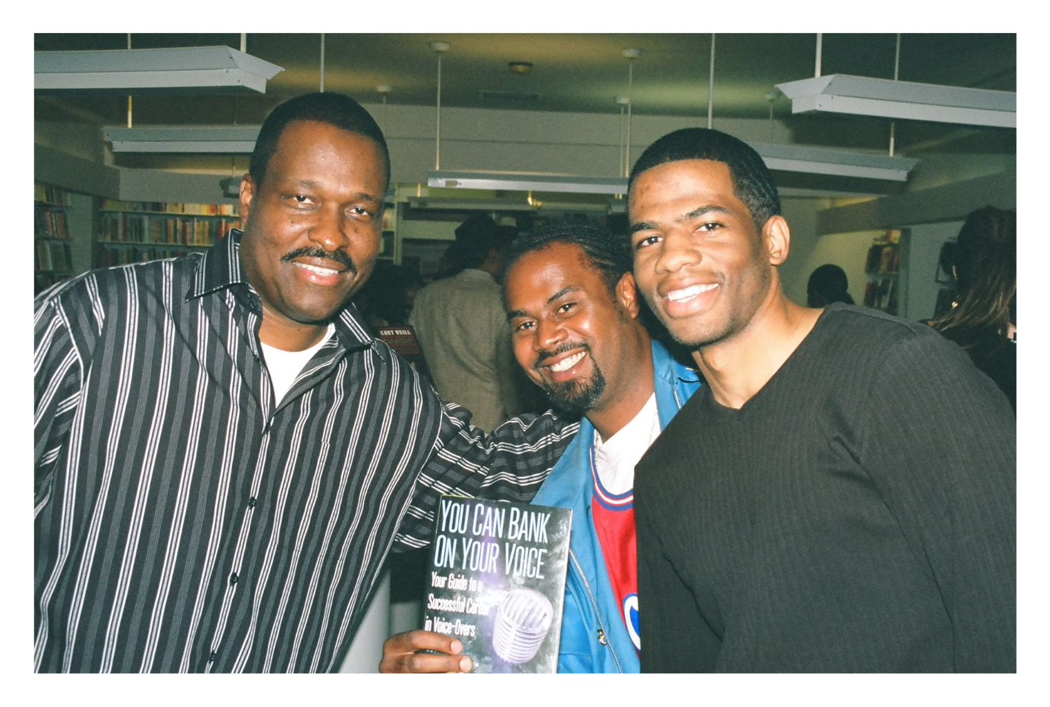 Rodney takes a photo with a couple of attendees at the 2004 book signing of his best seller 