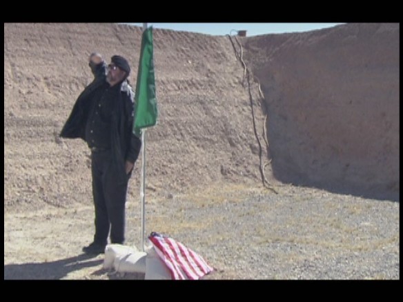 J. Neil Schulman as Ali, in a scene from Lady Magdalene's, in which as an al Qaeda operative he has just thrown the American flag on the ground and hoisted an al Qaeda flag.