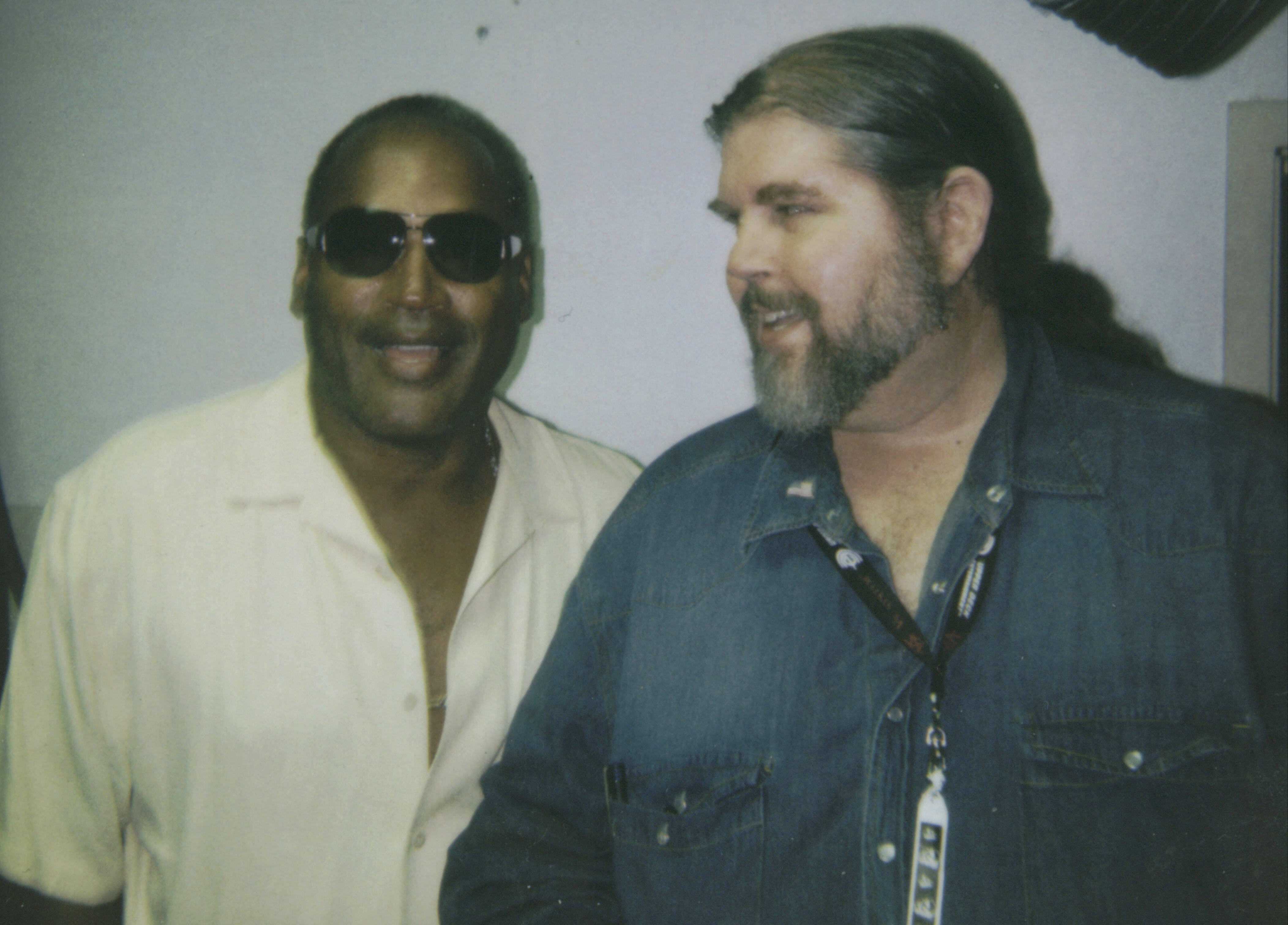 J. Neil Schulman, author of The Frame of the Century?, photographed with the subject of his journalistic investigation, O.J. Simpson, following an hour in which Schulman sat with Simpson while Simpson was autographing sports memorabilia at the October 1, 2005 NecroComicon Convention. The photograph was taken by Thomas Riccio, whose testimony later convicted Simpson of armed robbery of property Simpson claimed was his own in a Las Vegas casino hotel.