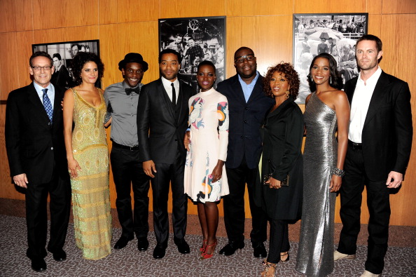 Director Steve McQueen joins members of the cast for a photo at the Los Angeles Premiere of 