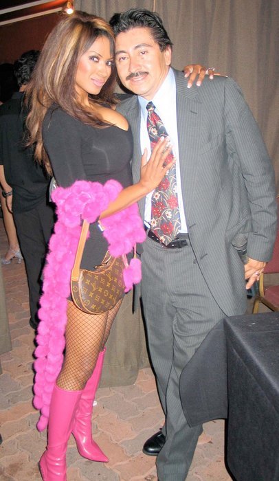 CENTURY CITY, CA - SEPTEMBER 24 Actress/master of ceremonies Traci Bingham and actor/producer/host of Upfront Entertainment Television Alexander Sibaja pose backstage at Venus Swimwear Finals at Century Club on September 24, 2004 in Century City, California.