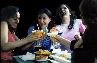 Barbara Sicuranza, as Graziella, laughing at right on a poster for Margarita Happy Hour.