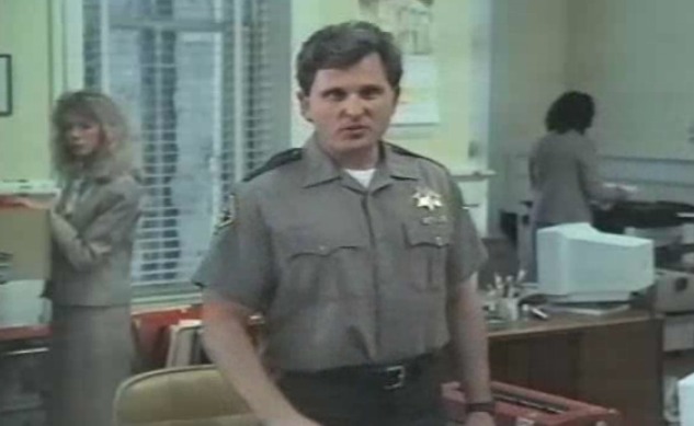 Tim Simek as the Deputy in 