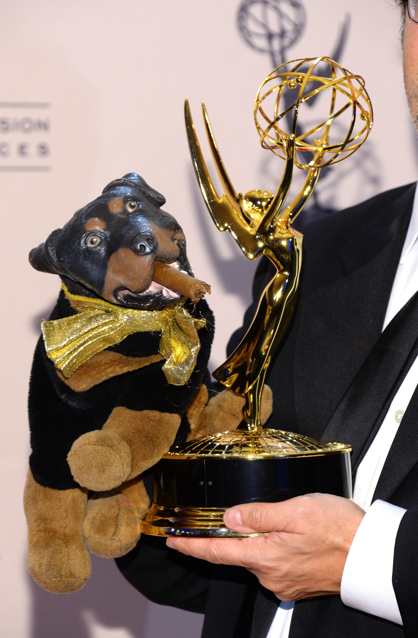 Robert Smigel holds 'Triumph the Insult Comic Dog' along with the award for outstanding interactive program for 