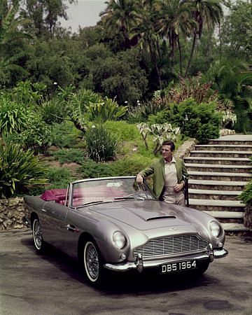 ROBERT STACK AT HOME IN BEVERLY HILLS CA. WITH HIS 1964 ASTIN MARTIN DB5, 1964