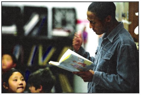 Ezra J. Stanley reads children's literature to fourth grade classes as part of the Screen Actors Guild BookPALS volunteer program.