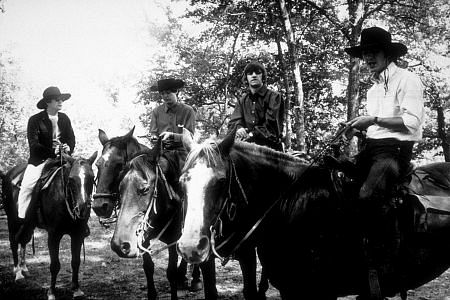 The Beatles (John Lennon, Paul McCartney, Ringo Starr, and George Harrison) on horseback in Ozarks, Arkansas c. 1965
