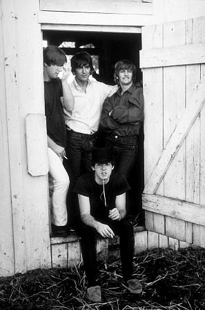 The Beatles (John Lennon, George Harrison, Paul McCartney, & Ringo Starr hanging out by a barn door.) in Ozarks, Arkansas, c. 1965