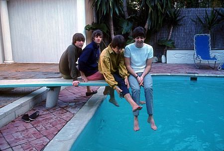 The Beatles (John Lennon, Ringo Starr, George Harrison, Paul McCartney) on the diving board by the poolside,