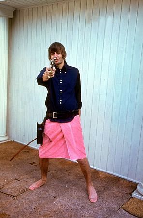 The Beatles, (Ringo Starr wearing a towel on his waist and playing with his gun), 1964