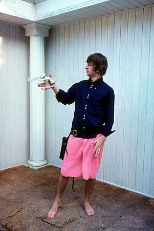 The Beatles, (Ringo Starr in a pink towel twirls his gun )
