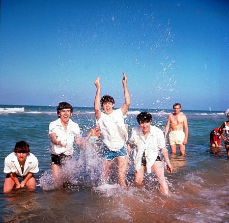 The Beatles (Ringo Starr, George Harrison, Paul McCartney, John Lennon, splashing around in public waters),