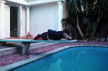 The Beatles ( Ringo Starr lies belly position on the diving board while pointing his gun)