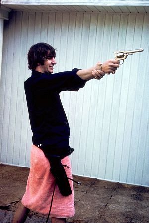 The Beatles (Ringo Starr grips his right wrist to steady his gun positioning)