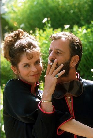 Ringo Starr smokes a cigaretee while wife give him a hug
