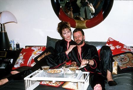 Ringo Starr and wife Barbara Bach in bed with some snacks.