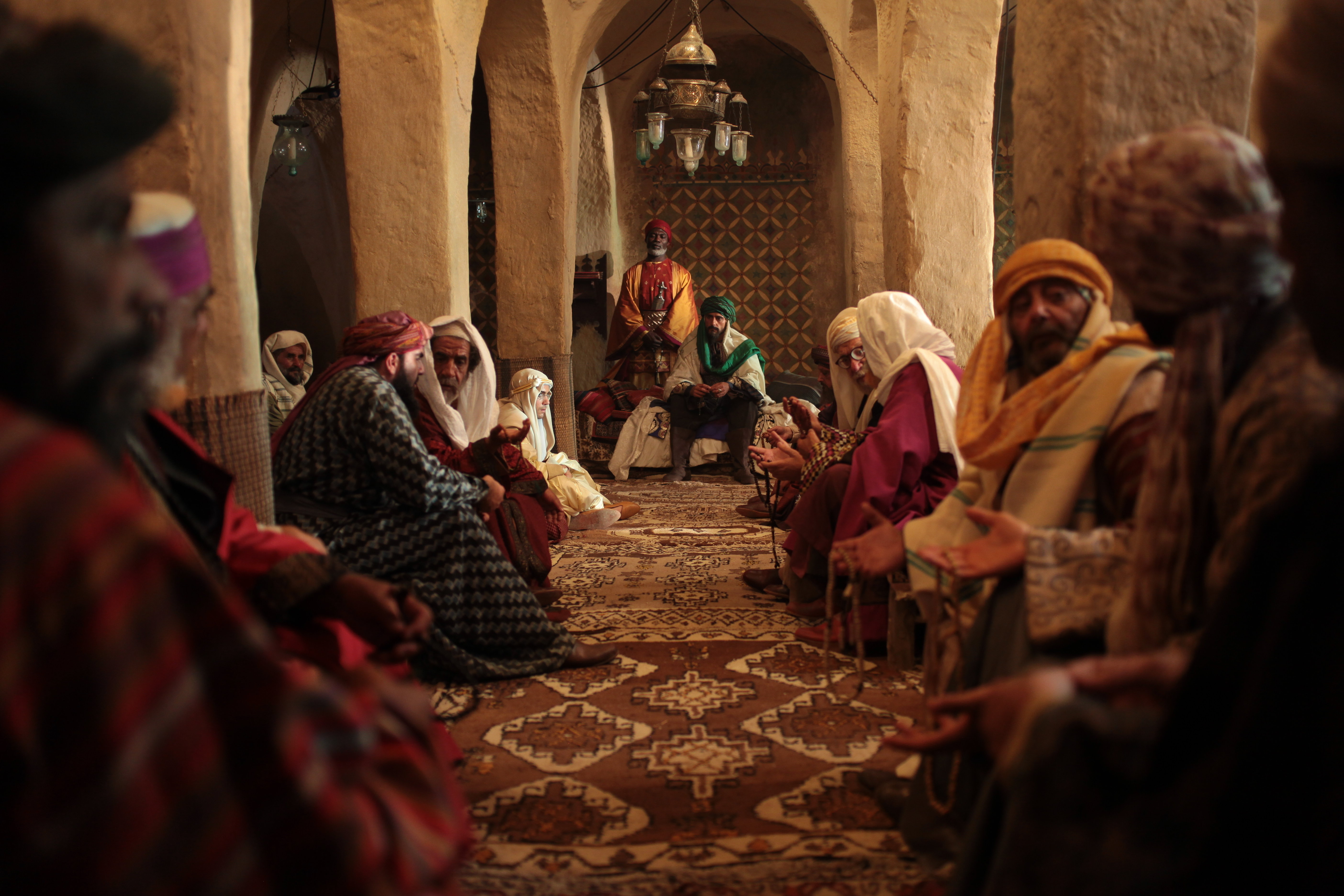Sultan Amar (Mark Strong) ruler of Salmaah sits with his advisors