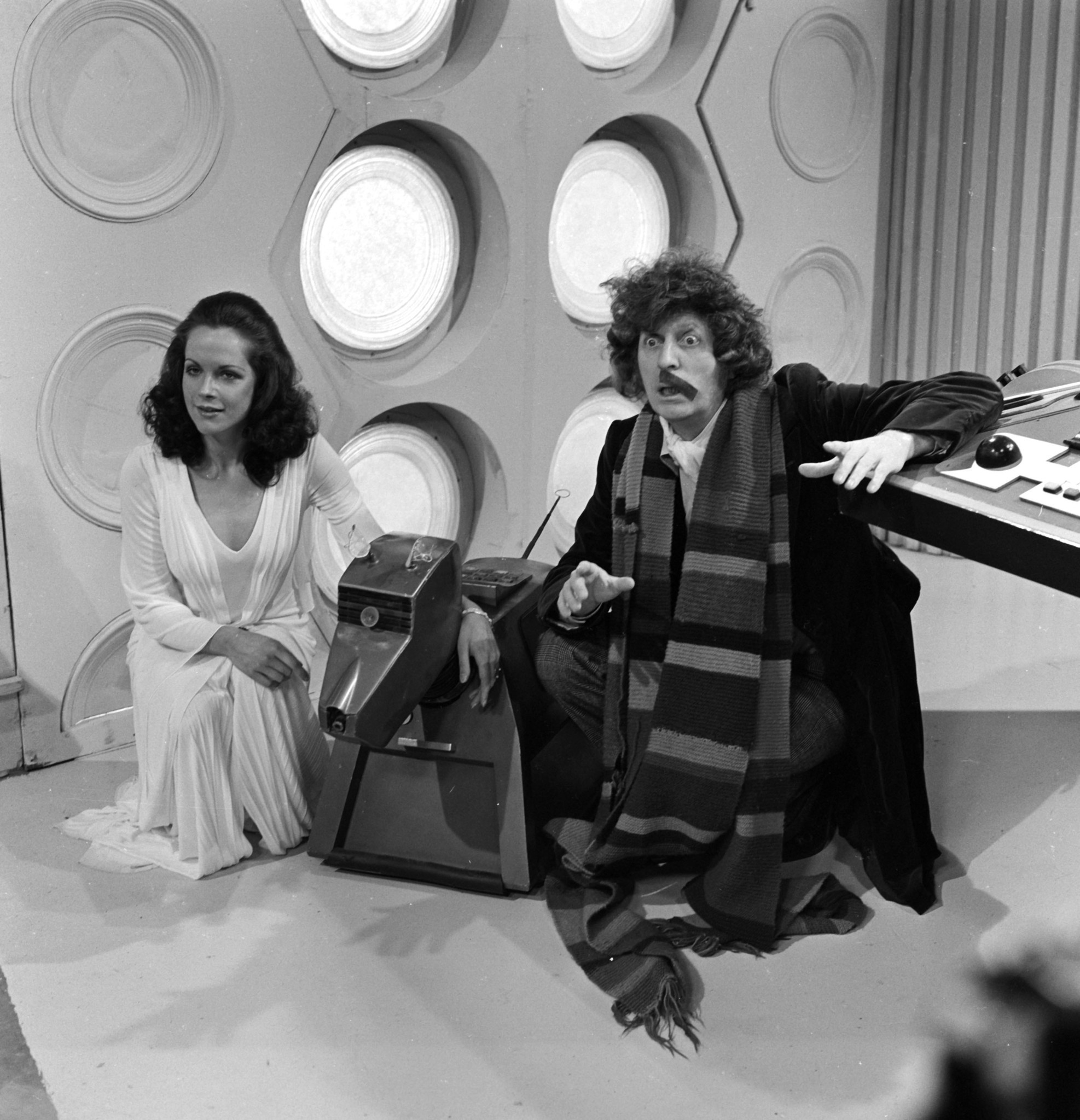 British actor Tom Baker who plays the Doctor in the BBC Television Series Dr Who. Pictured here with his assistant Romana played by Mary Tamm and the robot dog K9.