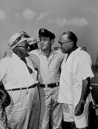 Elvis Presley, Norman Taurog (director), and Hal B. Wallis (producer) on location for 