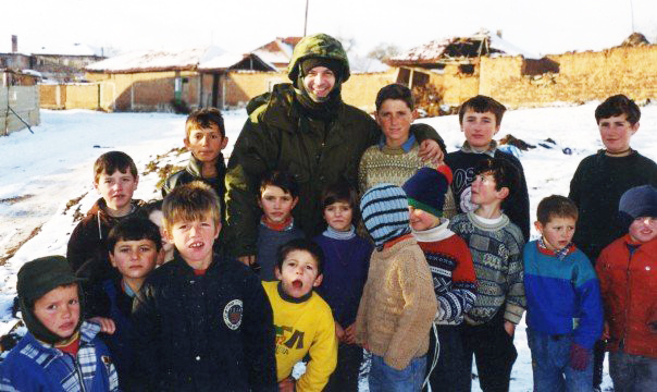 Mark Terry with the homeless children of Kosovo during the filming of We Stand on Guard, 2000.