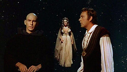 Andreas Teuber as Mephistopheles, Elizabeth Taylor as Helen of Troy and Richard Burton as Faustus in the film version of DR. FAUSTUS.