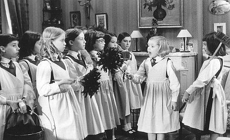 Madeline (Hatty Jones, second from right) and faithful helper Aggie (Clare Thomas, far right) instruct their schoolmates in the fine art of housecleaning.