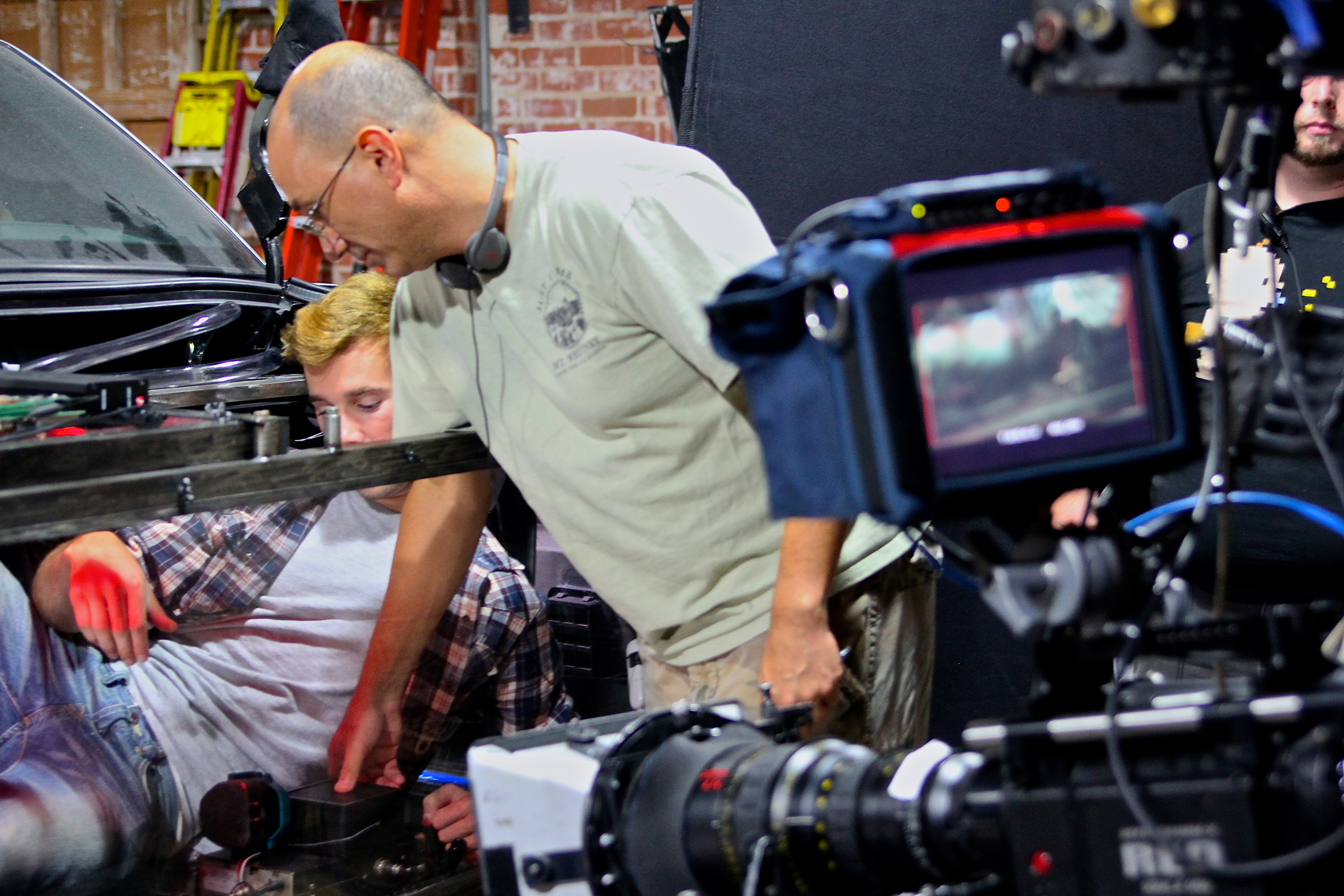 Director Gabe Torres lines up a shot on the set of BRAKE. 2010