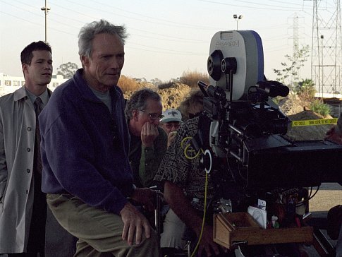 DYLAN WALSH, left, looks on as director and star CLINT EASTWOOD sets up a shot for Malpaso Productions' suspense thriller 