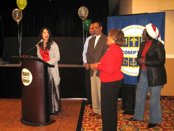 Los Angeles, CA -- Linda Wang (left) the recipient of the yearly Goodwill Award at the 56th Annual Compton Christmas parade dinner event with Compton City's officials.
