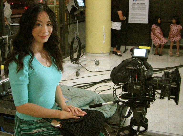 Chinese Daily News: Still Photograph of Linda Wang filming on set for the Irsih band 