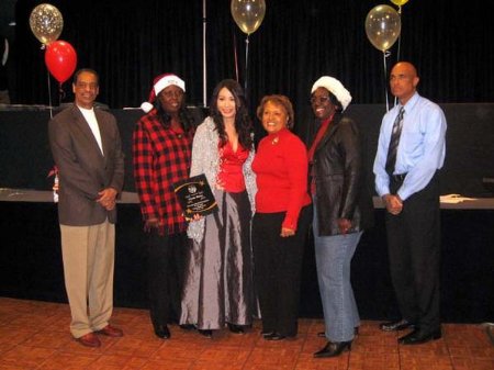 Los Angeles, CA -- Linda Wang (center) the recipient of the yearly Goodwill Award at the 56th Annual Compton Christmas parade dinner event with Compton City's officials.
