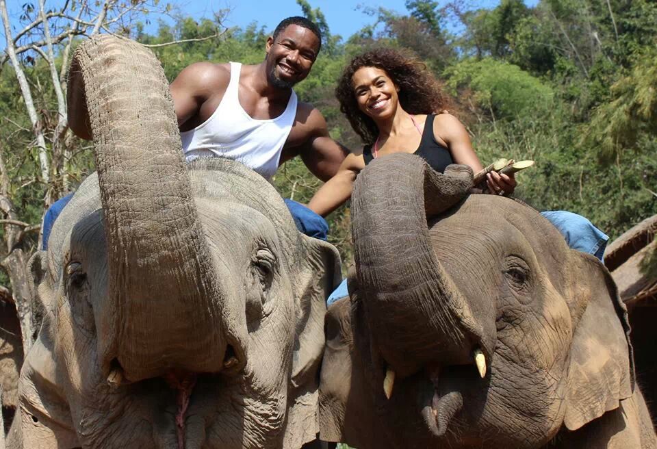 Couple Michael Jai White and Gillian Iliana Waters riding elephants in Thailand during White's filming of his new action movie Skin Trade.