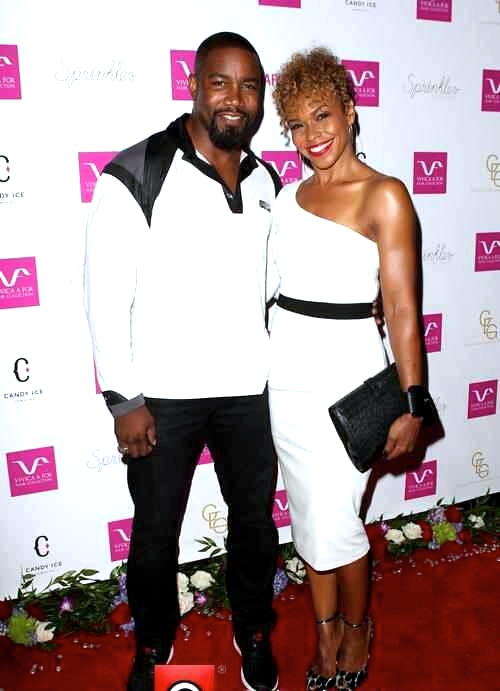 Gillian Waters and fiancee Michael Jai White on the red carpet at Vivica Fox's 50th birthday celebration in Beverly Hills.