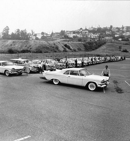 Lawrence Welk and his band with donated cars from his sponser, Chrysler