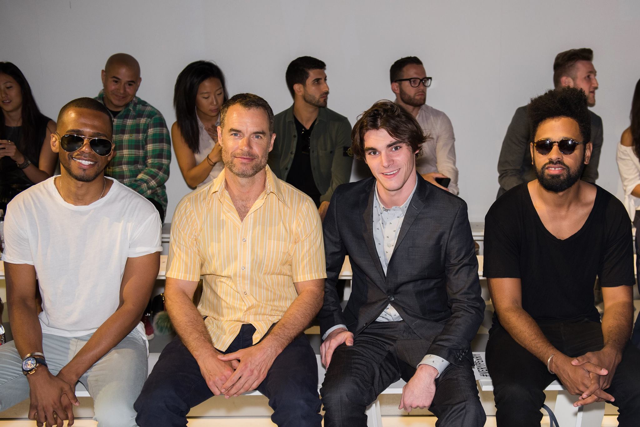 Actors Eric West, Murray Bartlett and RJ Mitte sit front row at Perry Ellis during New York Fashion Week: Men's S/S 2016 at Skylight Clarkson Sq on July 16, 2015 in New York City.