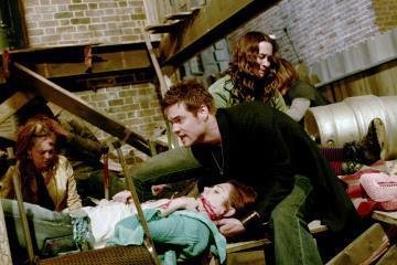 Adrienne Wilkinson (playing Jessica) cradled by Shane West (Dr. Ray) after the balcony has collapsed during a party, in an episode of ER.