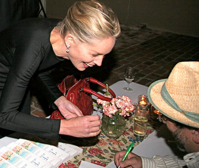 Sharon Stone gets her copy of the book 