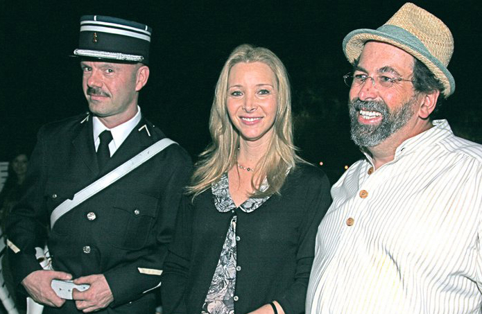 A French gendarme watches over Lisa Kudrow and author William Widmaier at the release party for his book 