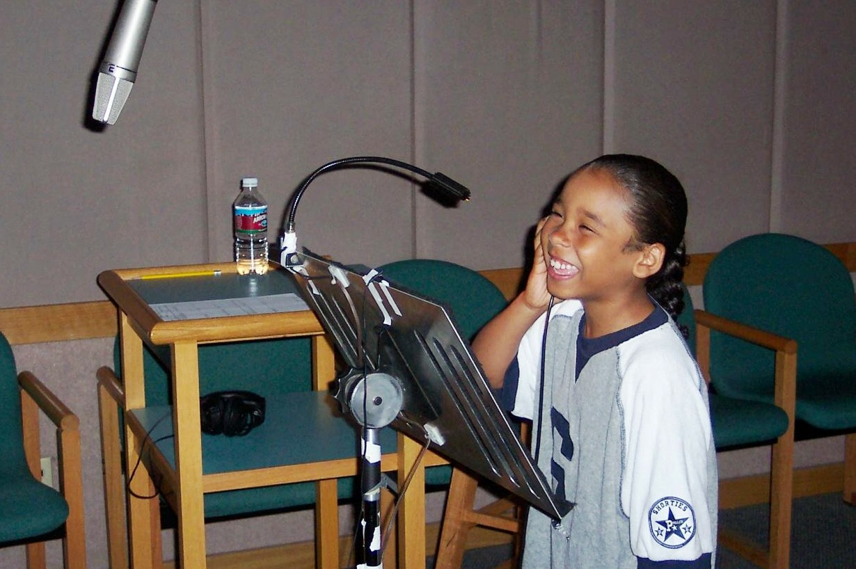 Zachary recording a voice in the studio.