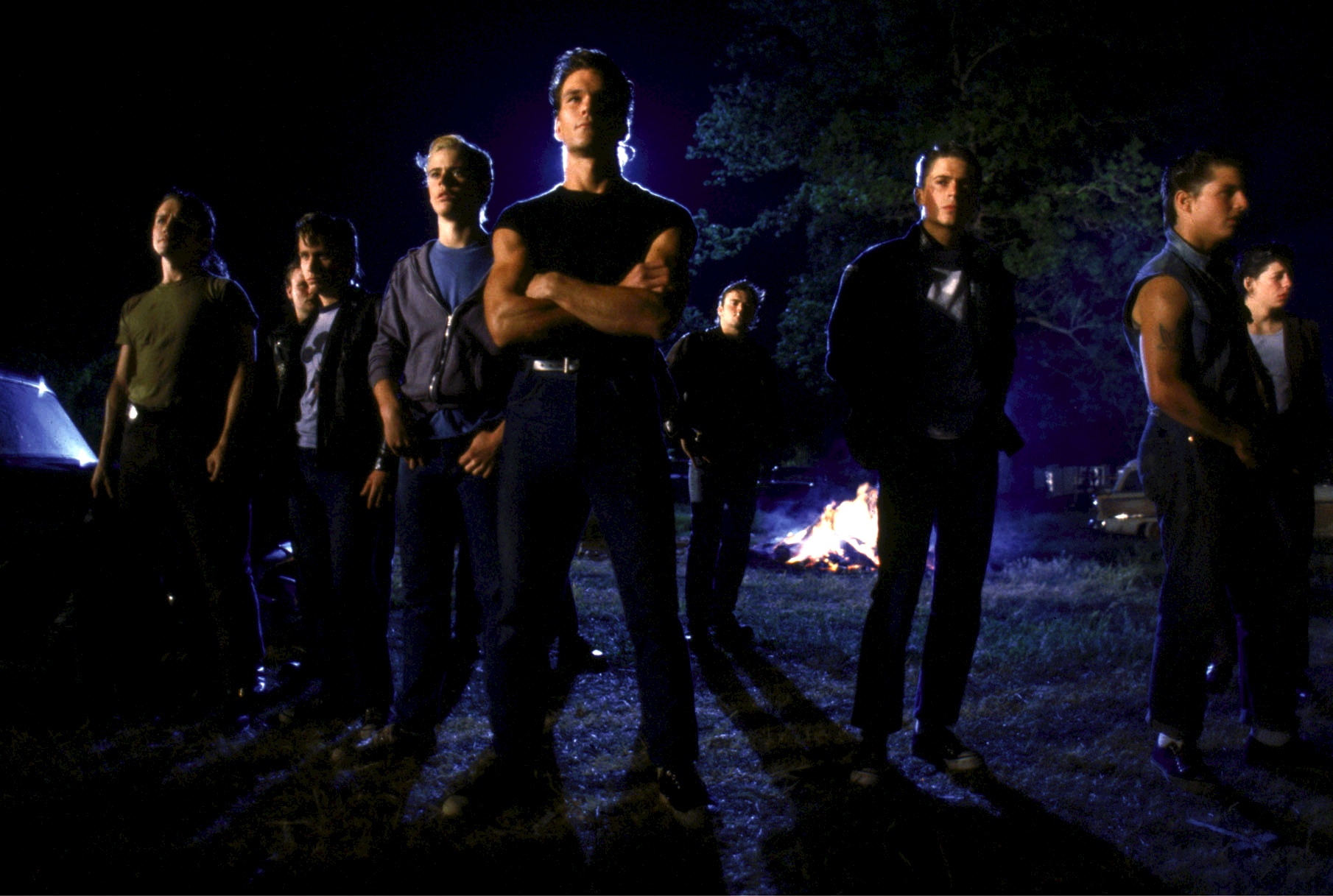 Still of Tom Cruise, Emilio Estevez, Rob Lowe, Patrick Swayze, C. Thomas Howell and Glenn Withrow in The Outsiders (1983)