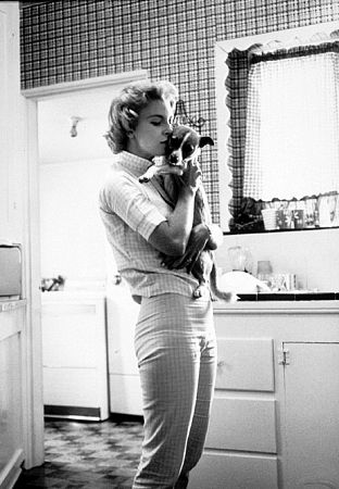 Joanne Woodward with her pet dog at home in Beverly Hills, CA, 1958.