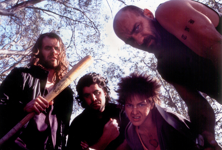 Photographic still from the true crime feature film CHAOS. Left to right: Stephen Wozniak as 'Frankie', Sage Stallone as 'Swan', KC Kelly as 'Daisy' and Kevin Gage as 'Eddie 